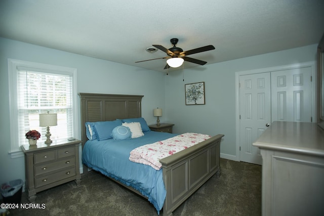 bedroom featuring dark colored carpet and a ceiling fan