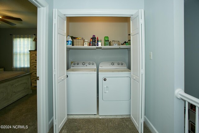 laundry area featuring ceiling fan, laundry area, baseboards, washer and dryer, and dark colored carpet