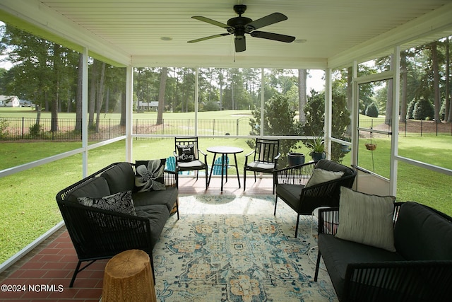 sunroom featuring a ceiling fan