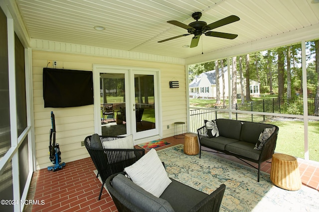 sunroom / solarium with a ceiling fan and wooden ceiling