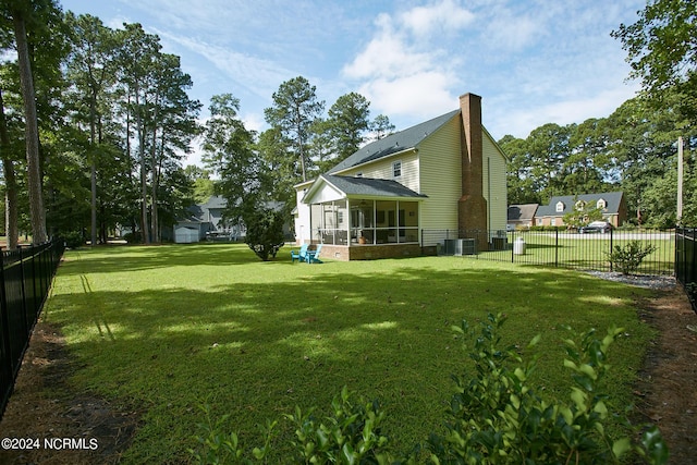 view of yard with a sunroom and fence