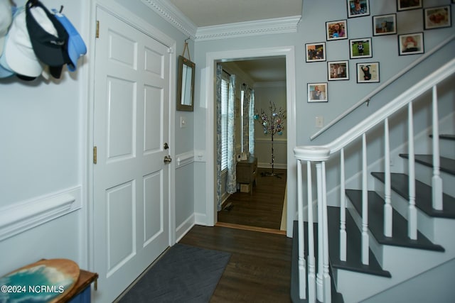 interior space with baseboards, dark wood-type flooring, stairway, and crown molding