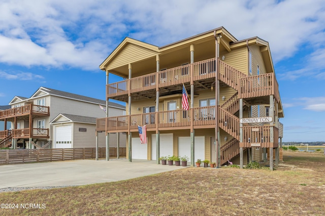 exterior space with concrete driveway, stairway, and an attached garage