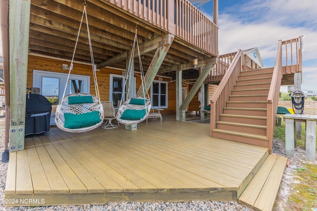 wooden terrace with stairs and a grill