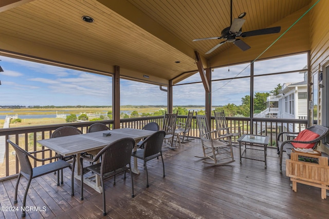 wooden terrace featuring outdoor dining area and ceiling fan