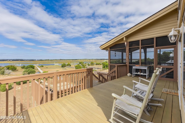 wooden deck with a water view and a sunroom