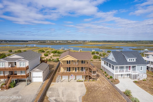 drone / aerial view with a water view and a residential view