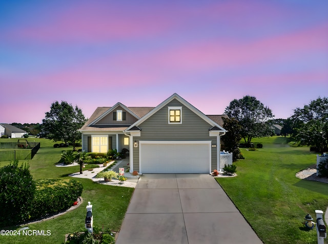 view of front of house with a garage and a lawn