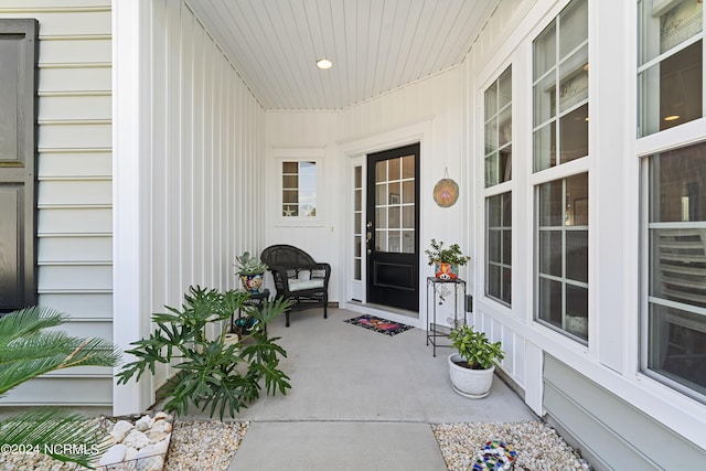 view of exterior entry featuring covered porch