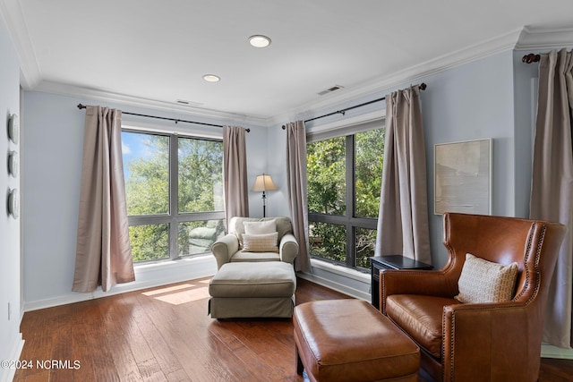 living area with crown molding and dark hardwood / wood-style floors