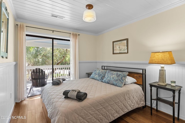 bedroom featuring wood-type flooring, access to outside, and ornamental molding