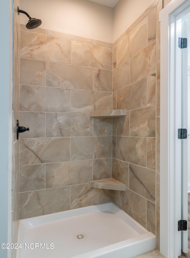 full bathroom with a tile shower