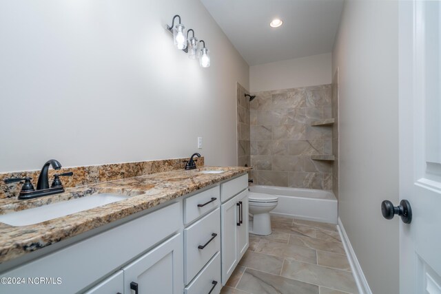 bathroom with shower / bathtub combination, double vanity, a sink, and toilet