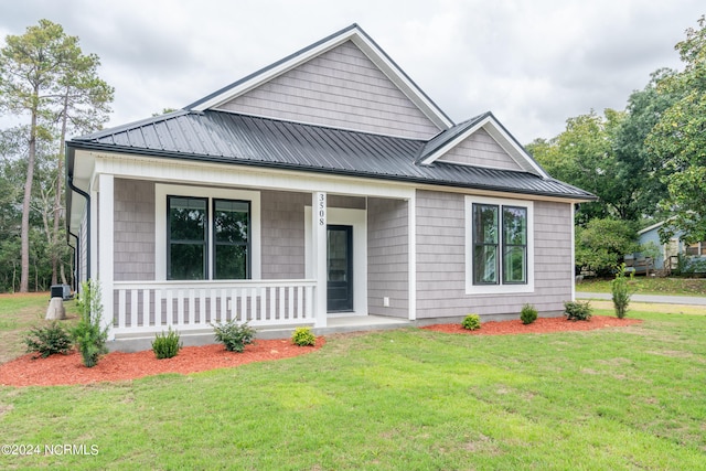 view of front of home featuring a front yard and a porch