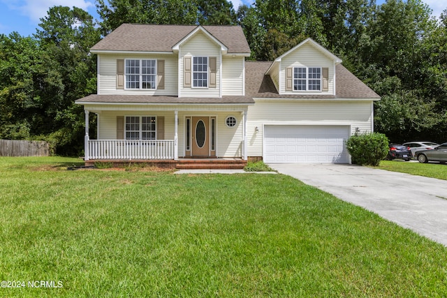 view of front of home with a porch, a front yard, and a garage