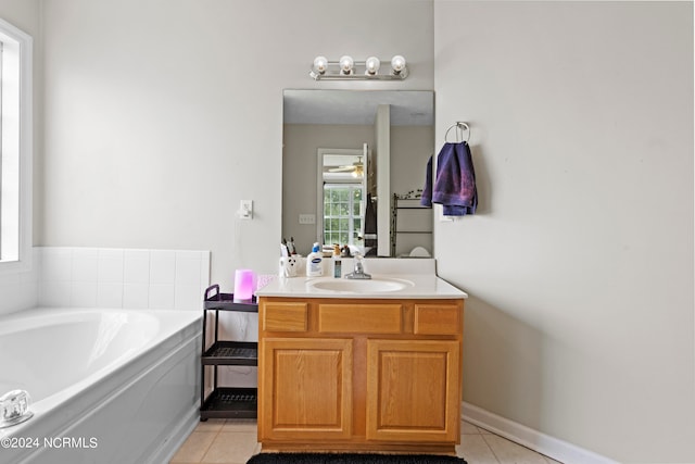 bathroom featuring vanity, a tub, and tile patterned floors