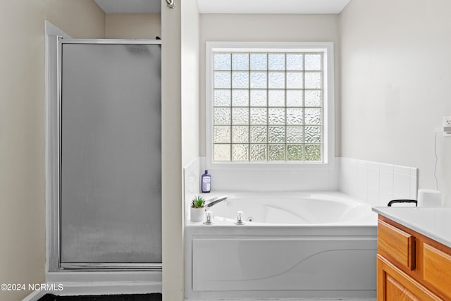 bathroom with independent shower and bath and vanity