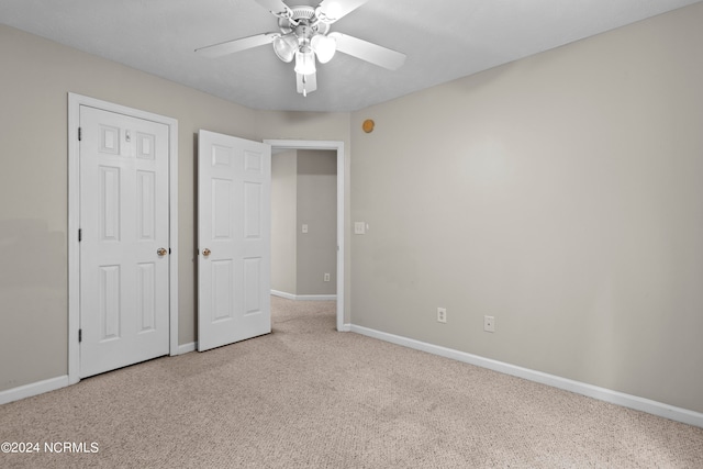 unfurnished bedroom with light carpet and ceiling fan