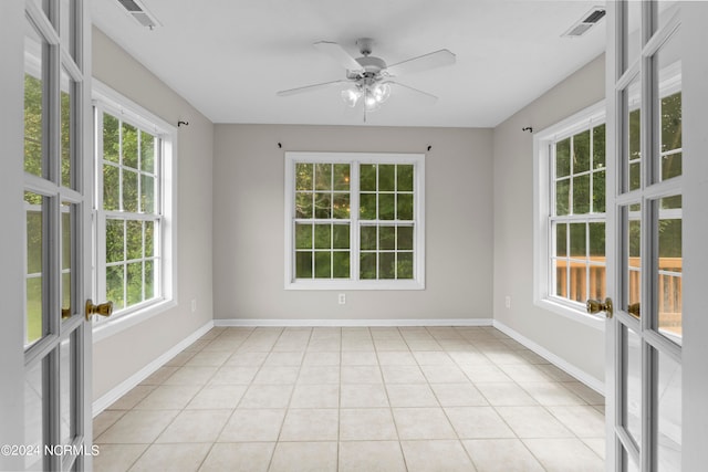 unfurnished sunroom featuring plenty of natural light and ceiling fan