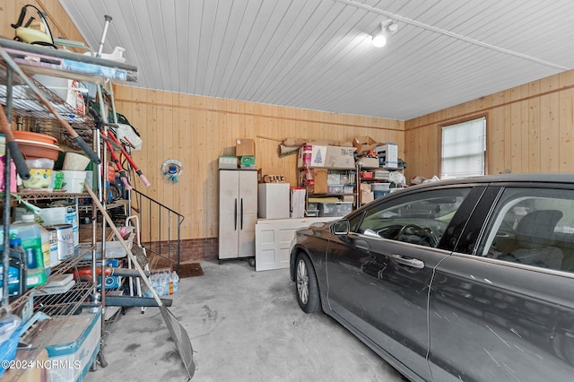 garage featuring wood walls and white refrigerator