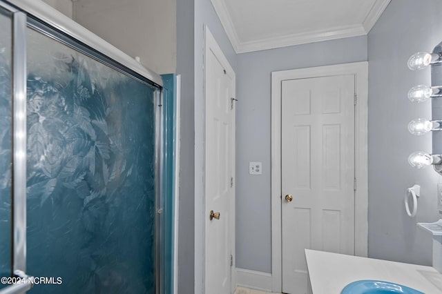 bathroom with walk in shower, vanity, and ornamental molding