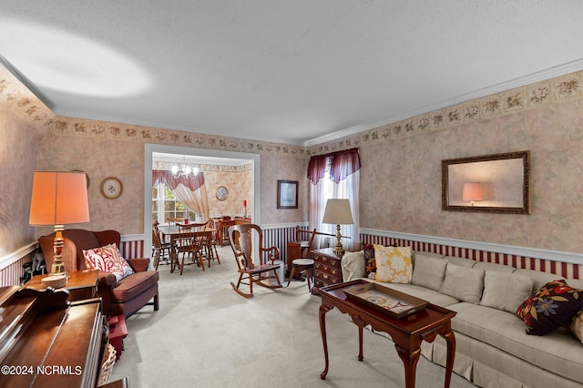 carpeted living room featuring an inviting chandelier, a textured ceiling, and crown molding