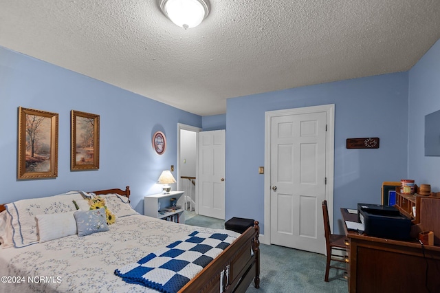 carpeted bedroom with a textured ceiling