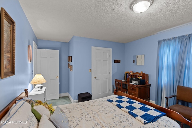 carpeted bedroom with a textured ceiling