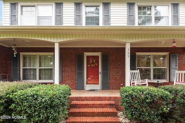 view of exterior entry with covered porch