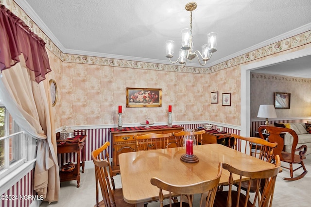 carpeted dining area featuring a chandelier, a textured ceiling, and crown molding