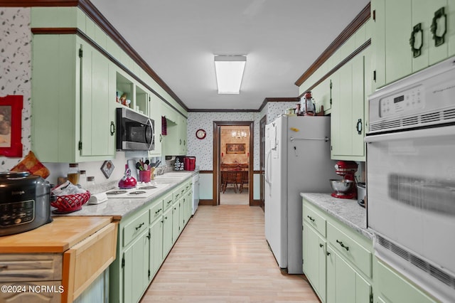 kitchen with light hardwood / wood-style floors, sink, green cabinets, white appliances, and crown molding