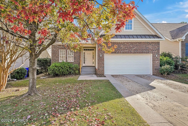 view of front of home featuring a front yard and a garage