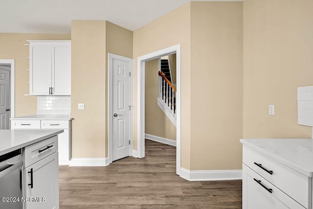 5104 Boss Ct SE, Southport, NC 28461 - kitchen with light wood-type flooring, light countertops, baseboards, white cabinetry, and open shelves