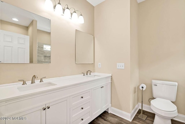 5104 Boss Ct SE, Southport, NC 28461 - full bathroom featuring baseboards, double vanity, toilet, and wood finished floors