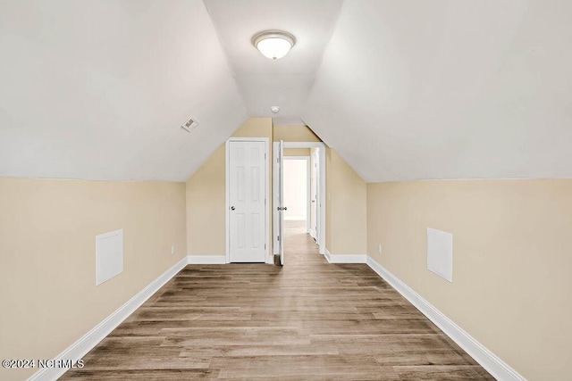 5104 Boss Ct SE, Southport, NC 28461 - bonus room featuring wood finished floors, baseboards, and vaulted ceiling