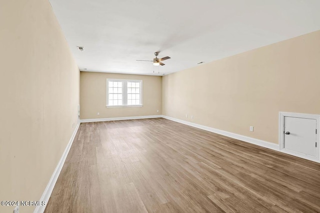 5104 Boss Ct SE, Southport, NC 28461 - empty room featuring ceiling fan, wood finished floors, and baseboards