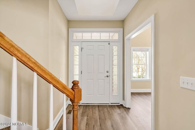 5104 Boss Ct SE, Southport, NC 28461 - foyer entrance featuring wood finished floors, baseboards, and stairway
