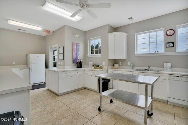 5104 Boss Ct SE, Southport, NC 28461 - kitchen featuring white appliances, a sink, a peninsula, ceiling fan, and white cabinets