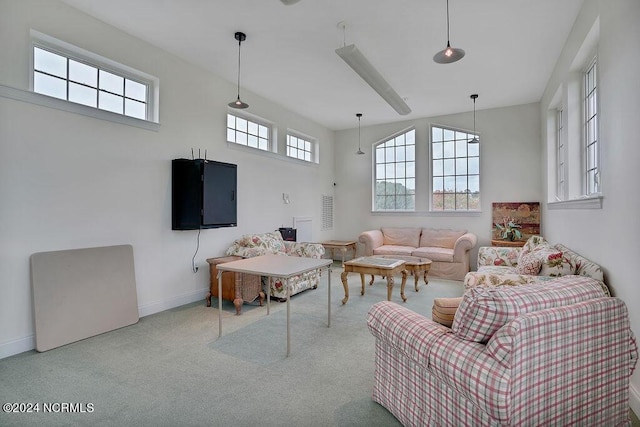 5104 Boss Ct SE, Southport, NC 28461 - living area with carpet floors, a towering ceiling, and baseboards