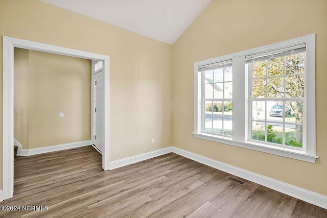 5104 Boss Ct SE, Southport, NC 28461 - empty room featuring wood finished floors, lofted ceiling, and baseboards