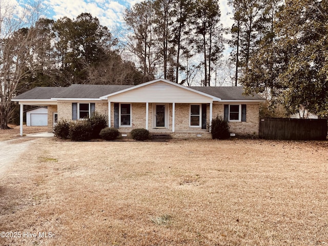 ranch-style house featuring a garage, a porch, and a front yard