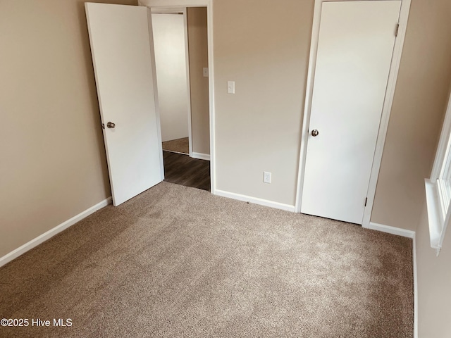 unfurnished bedroom featuring dark colored carpet