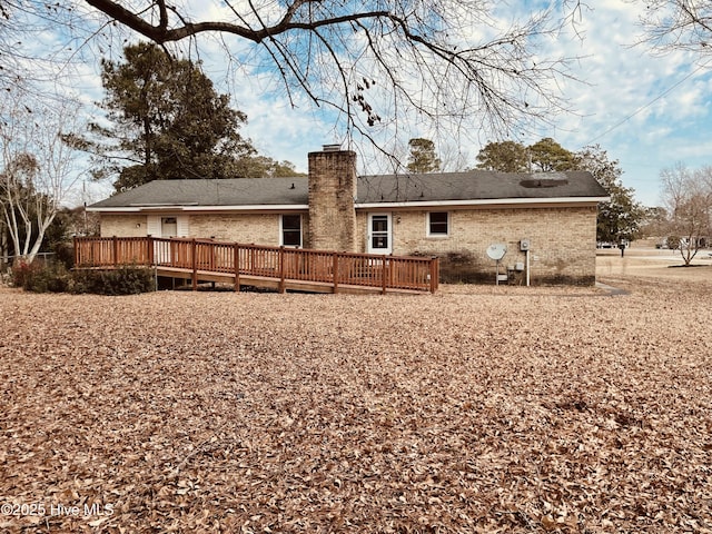 back of property with a wooden deck