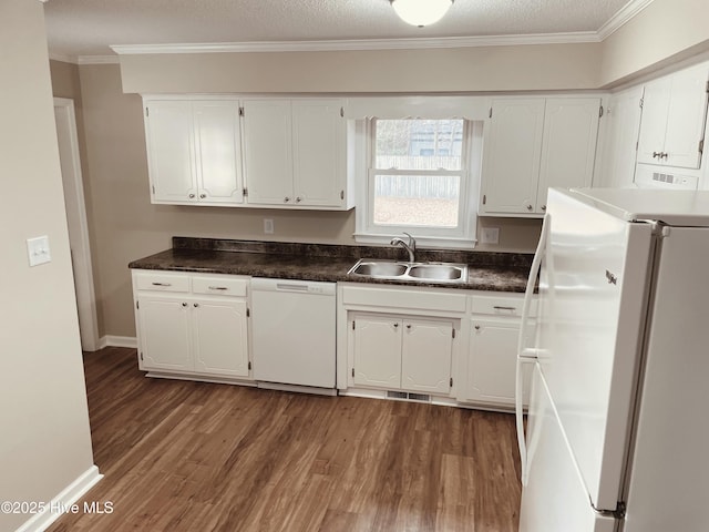 kitchen featuring dark wood-type flooring, sink, white cabinetry, ornamental molding, and white appliances