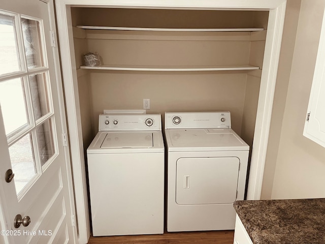 laundry area with hardwood / wood-style floors and washer and clothes dryer