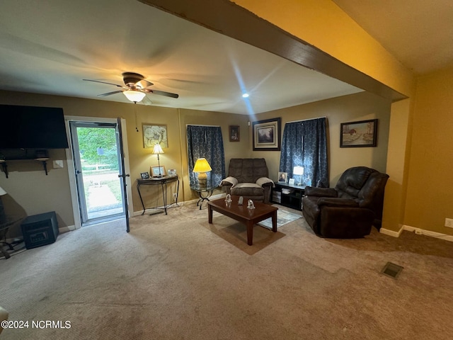 carpeted living room featuring ceiling fan