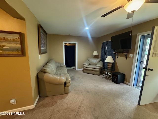 sitting room featuring ceiling fan and light colored carpet