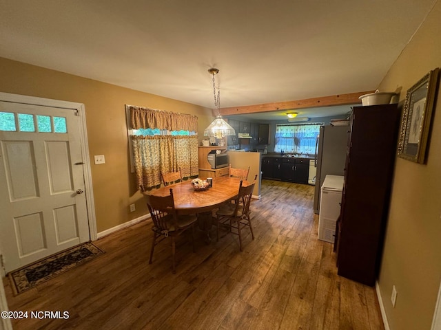 dining space with wood-type flooring and sink