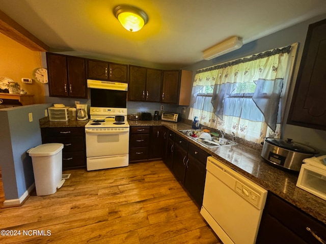 kitchen with white appliances, dark brown cabinets, light hardwood / wood-style flooring, and sink