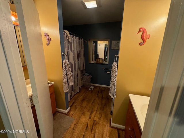 bathroom featuring vanity and hardwood / wood-style flooring